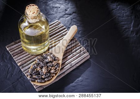 Beans And Castor Oil On The Black Table