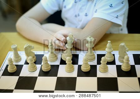 Details Of The Hands Of A 12 Years Old Chess Master Playing With Chess Pieces On A Chess Board