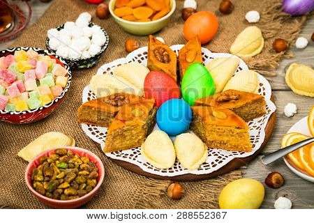 Novruz Ramadan In Azerbaijan. Colored Eggs, Wheat Springs For Easter And Traditional Sweets. Selecti