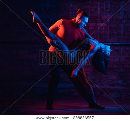 Professional Dancers Perform An Incendiary Dance In A Dark Room With Illumination