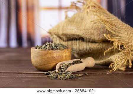 Lot Of Pieces Of Dry Green Tea With Wooden Bowl With Silk Curtains