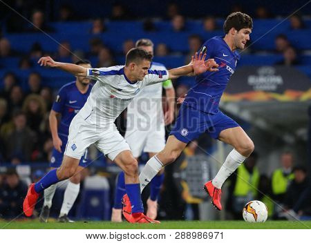 LONDON, ENGLAND - MARCH 7 2019: Volodymyr Shepelyev of Dynamo Kiev and Marcos Alonso of Chelsea during the Europa League match between Chelsea and Dynamo Kyiv at Stamford Bridge.