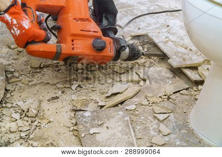 Demolition Of Old Tiles With Jackhammer. Renovation Of Removes Old Tiles From Floor