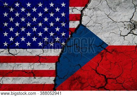 Us And Belgium Flag On Textured Cracked Ground. The Concept Of Cooperation Between The Two Countries