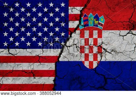 Us And Belgium Flag On Textured Cracked Ground. The Concept Of Cooperation Between The Two Countries