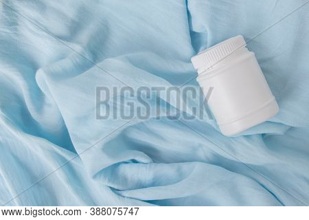 White Plastic Jar With Vitamins And Bioactive Additives. Useful Pills For Youthful Skin On A Beautif