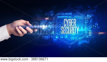 hand holding wireless peripheral with CYBER SECURITY inscription, cyber security concept