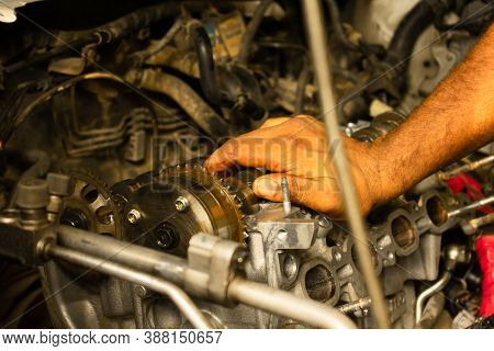 Repair Car Engine And Close Up Hand Of Worker Man In Automotive Service Center Or Garage