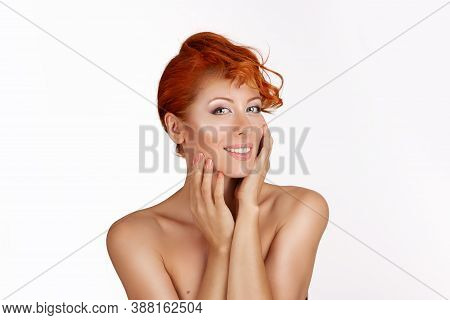 Beautiful Young Woman With Redhead, Ginger Culry Hair  Looking At You Smiling Slightly Hands Around 