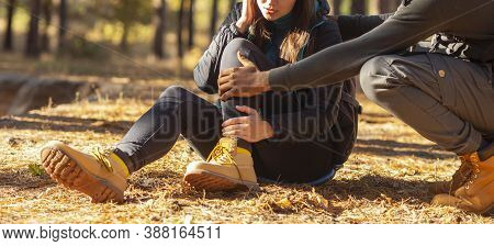 Cropped Of Black Guy Rubbing His Girlfriend Ancle, Woman Got Injured While Hiking In Forest, Panoram