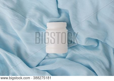 White Plastic Jar With Vitamins And Bioactive Additives. Useful Pills For Youthful Skin On A Beautif