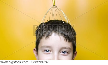 A Caucasian Boy Enjoy Head Scalp Massage By Anti Stress Acupuncture Metal Octopus Tool, Equipment, S