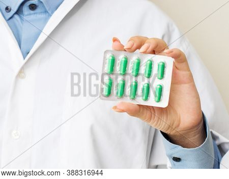 Female Doctor Showing Pills In The Hands Of A Close-up. The Appointment Of Treatment.