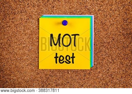 Reminder Mot Test On Yellow Note Paper With On Corkboard