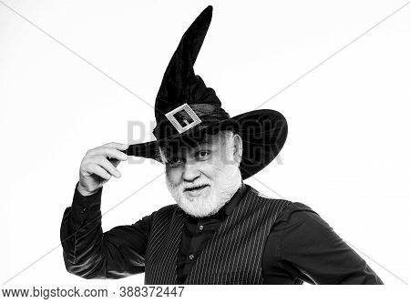 Mature Man Magician In Witch Hat. Bearded Man Ready For Halloween Party. Evil Wizard. Stargazer Or A