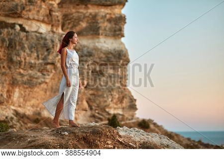 Carefree Woman In Dress Posing On Nature. Blue Sky And Fresh Air. Contemplation Time And Self Absorb