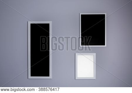 Poster Mockup With Three Frames On Empty Grey Wall