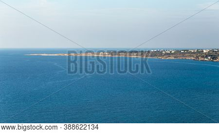 Panoramic View Of The Blue Sea. View Of A Piece Of Land In The Sea, Island, Sky, Clouds.