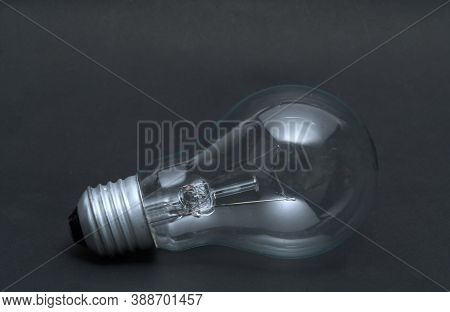 Abstract Previously Used Light Bulb Concept On Black Isolated Background.