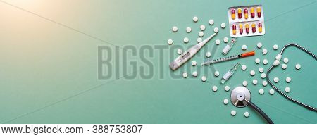 Pills, Ampoule, Syringes, Capsules, Stethoscope On The Green Doctor S Table. Copy Space. Place For T