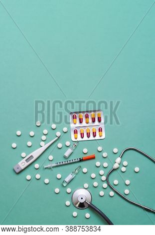 Pills, Ampoule, Syringes, Capsules, Stethoscope On The Green Doctor S Table. Copy Space. Place For T