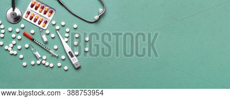 Pills, Ampoule, Syringes, Capsules, Stethoscope On The Green Doctor S Table. Copy Space. Place For T