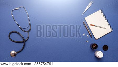 Medical Equipment Stethoscope, Syringe, Thermometer And Notebook On Pastel Blue Color, Healthcare An