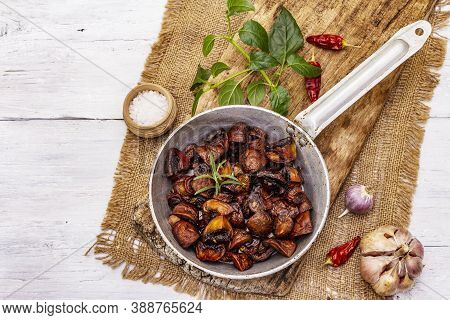 Ready To Eat Hot Fried Brown Champignons In Vintage Pan