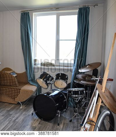Drum Set In The Room By The Window. Musicians Room Interior With Drum Kit. Modern Drum Kit In The Ro