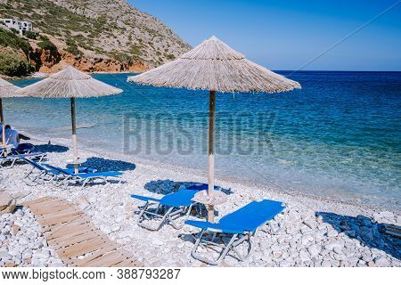 Plaka Lassithi With Is Traditional Blue Table And Chairs And The Beach In Crete Greece