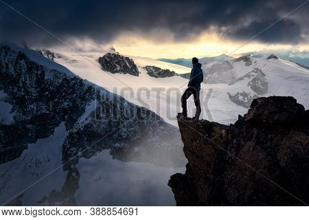 Man Hiker On Top Of A Mountain Peak. Dreamscape Artistic Render Composite. Landscape Background From