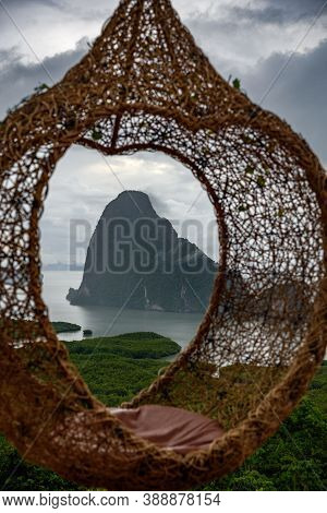 The Scenery Of The Sametnangshe Island Looks Through The Hanging Basket Wicker Chair In Phang-nga Pr