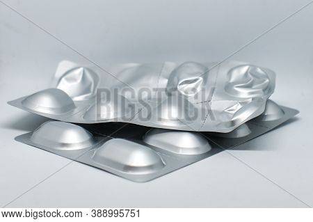 Silver Blister With Pills Isolated On Gray Background. Closed Silver Blister With Antibiotics. Packa