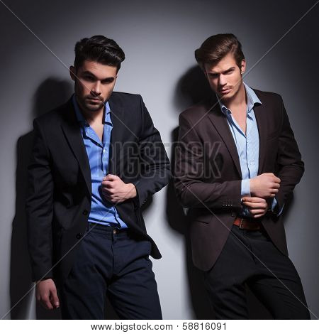 dramatic picture of two fashion male models looking at the camera