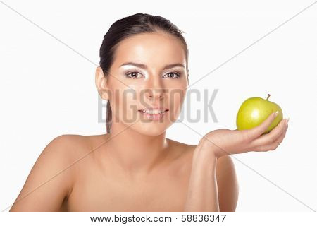 A portrait of beautiful young woman with a green apple on her hand - on white background