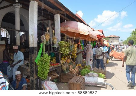 STONE TOWN, ZANZIBAR - DECEMBER 12: Sellers offer fruit and vegetables in the city market on 12 December 2013 in Stone Town, Tanzania.