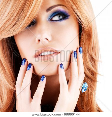 portrait of a beautiful woman with blue nails, blue makeup and  long red hairs  on white  background