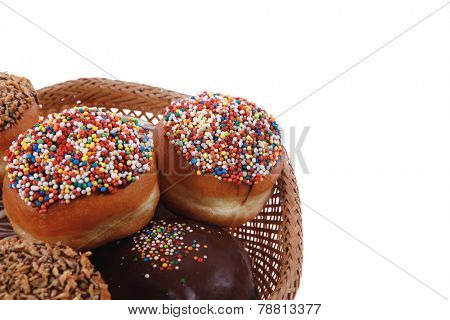 traditional jewish holiday chanuka donuts covered by dark chocolate on retro vintage basket isolated on white background