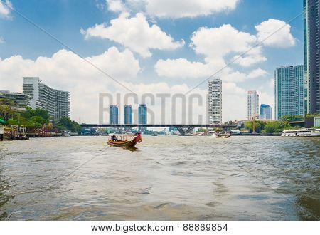 Scenic View Of The Chao Praya River In Bangkok Including Long Tail Boat And River Taxi