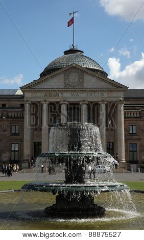 WIESBADEN, GERMANY - AUGUST 25, 2012: People walk in front of the Kurhaus in Wiesbaden, Hesse, Germany.