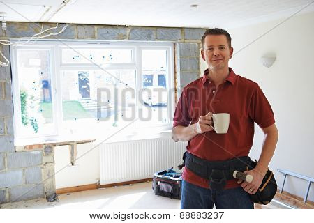 Builder Carrying Out Home Improvements Taking A Break