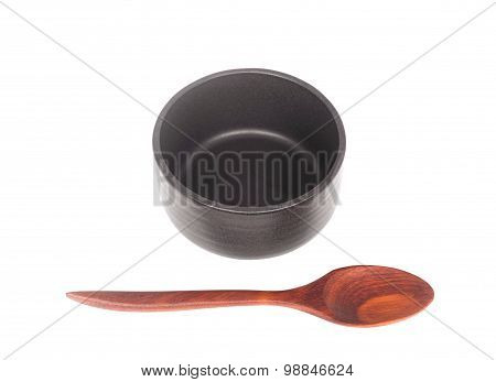 Black Ceramic Bowl With Wooden Spoon Isolated