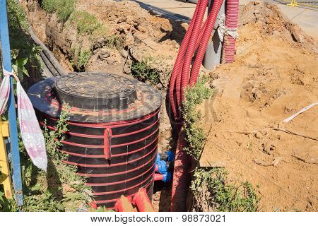 Excavation Pit, Electrical Cables And Optical Fibres In The Digging On A Construction Site