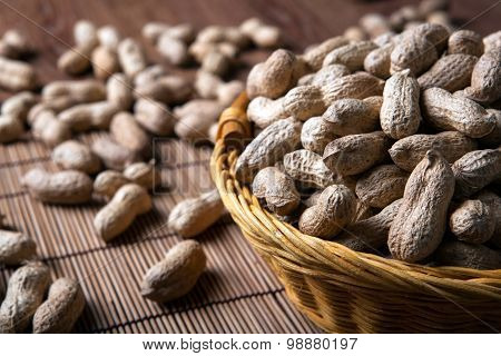 Large Grains Of Peanuts In The Shell And Basket