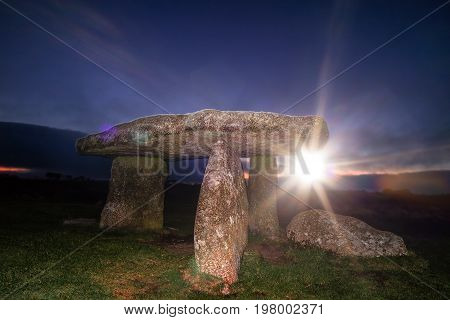 Lanyon Quoit Cornwall England UK during sunset with sunburst