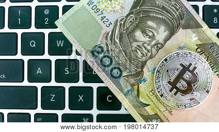 Bitcoin on Nigerian Naira banknote. Electronic money exchange concept