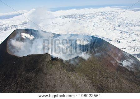 View of the mouth of an active Karymsky volcano from a helicopter in may 2016 on the Kamchatka Peninsula. Russia