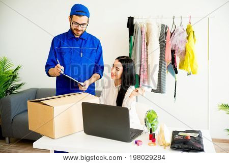 Woman accepting a box package from deliveryman