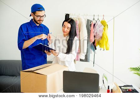 Woman accepting a box package from deliveryman