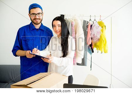Woman accepting a box package from deliveryman
